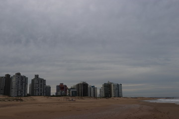 tower blocks next to the beach with grey overcast sky 