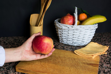 Fruit still life with a white basket and black background