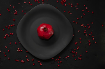 pomegranate on black background, pomegranate seeds