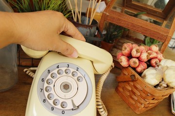 Vintage old telephone on brown wooden table