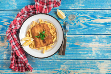 A piece of fried cod with fries on a plate.