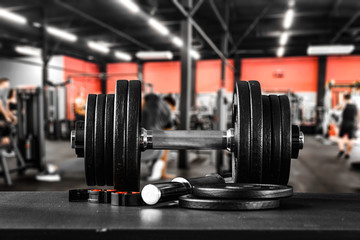 Fototapeta premium Dumbbell, barbell and workout in the gym. Running track and workout in the gym. Space with blurred gym background.