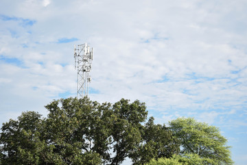 A cell phone tower with trees 4G 5G