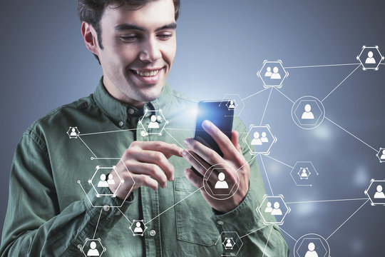 Cheerful man using smartphone, social network