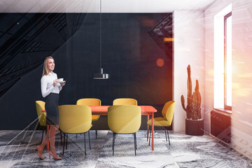 Blonde woman in white and black dining room