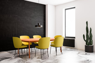 Black and white dining room corner, bright chairs