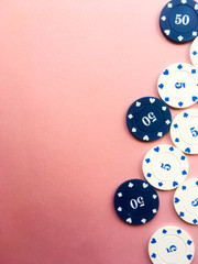 Poker chips on a pink background. Place for text.