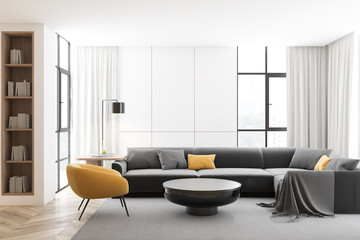 White living room with gray sofa and armchair