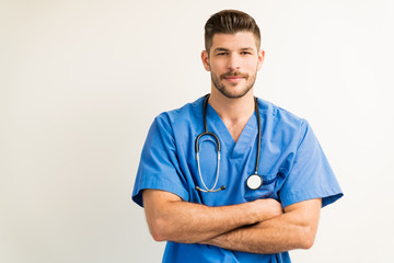 Portrait Of Young Surgeon Isolated Against Plain Background