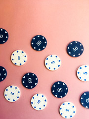 Poker chips on a pink background. Place for text.