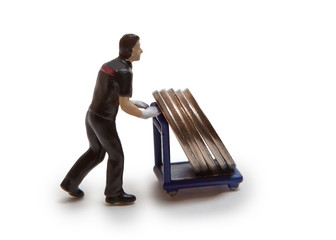 Man-doll carries coins on a cart, isolated on a white background.