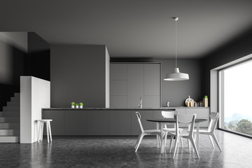 Gray kitchen with table and stairs