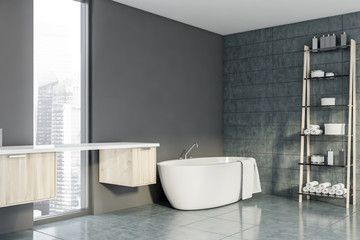 Obraz na płótnie Canvas Gray bathroom corner with tub and rack