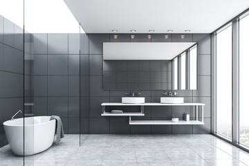 Gray tile and glass bathroom with tub and sink