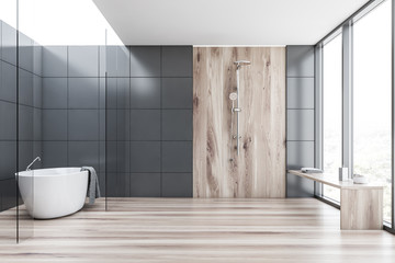 Gray tile and wood bathroom with tub and shower