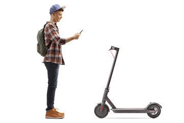 Teenage male student renting an electric scooter with a mobile phone application