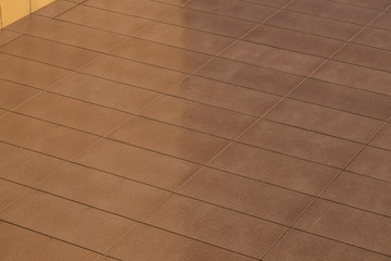 Angular view of light brown color tiled wall