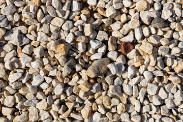 Close-up of many small light rocks on ground