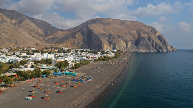 Aerial drone photo of famous volcanic beach and bay of Perissa village, Santorini island, Cyclades, Greece