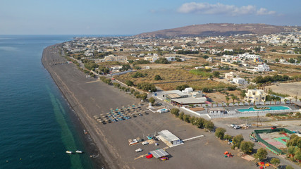 Fototapeta na wymiar Aerial drone photo of famous volcanic beach and bay of Perissa village, Santorini island, Cyclades, Greece