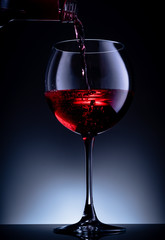glass of red wine on black background