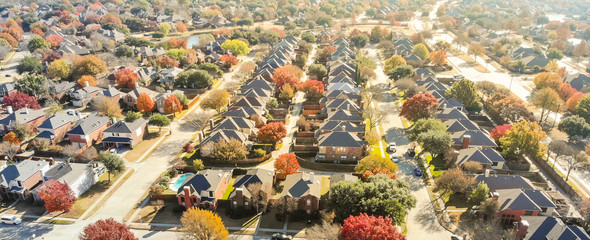 Aerial view row of new house with cul-de-sac (dead-end) and bright orange color fall foliage near...