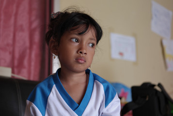 Little Asian girl showed sad expression. Cute Indonesian kid. 