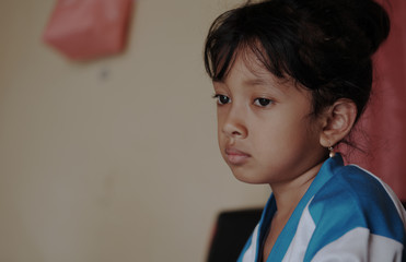 Little Asian girl showed sad expression. Cute Indonesian kid. 