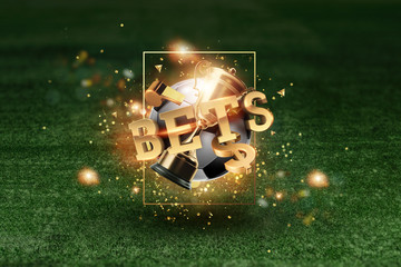 Golden Lettering Bets with soccer ball and green lawn background. Bets, sports betting, watch sports and bet.