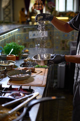 Food concept. The chef adds parmesan , The process of cooking spaghetti with seafood