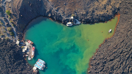 Aerial drone top down photo of iconic main Crater of Santorini volcanic island called Kameni visited by tourist boats, Cyclades, Greece © aerial-drone