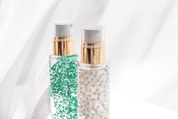 Skincare serum and make-up primer gel bottle, moisturizing lotion and lifting cream emulsion,...