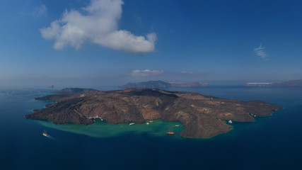Obraz premium Aerial drone top down photo of iconic main Crater of Santorini volcanic island called Kameni visited by tourist boats, Cyclades, Greece