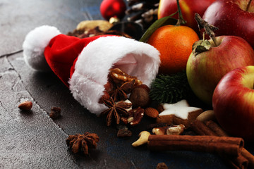 christmas cookies and santa had with spieses, nuts and fruits on rustic table