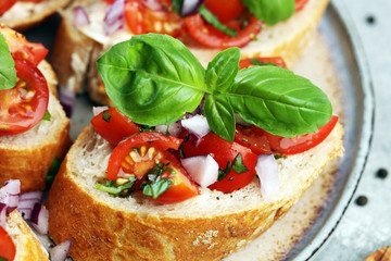 fresh tomato bruschetta. italian food appetizer with basil on table