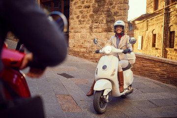 Smiling girl on scooter  at city. Bikers. © luckybusiness