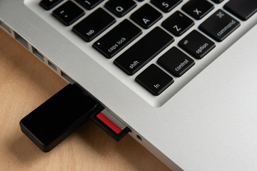 Close up of sd card card reader inserted in laptop