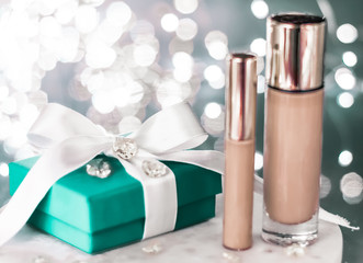 Holiday make-up foundation base, concealer and green gift box, luxury cosmetics present and blank...