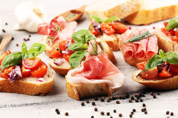 Assorted bruschetta with various toppings. Appetizing bruschetta or crudo crostini. Variety of small sandwiches. Mix bruschetta on table