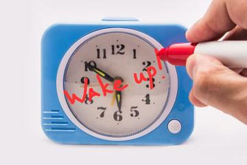 Alarm clock with the words wake up on the dial.