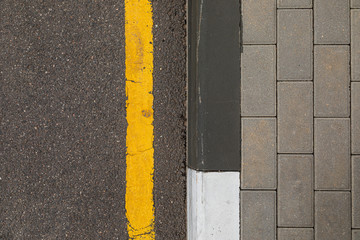 Fototapeta premium Yellow line prohibiting stop and parking for vehicles along trimming
