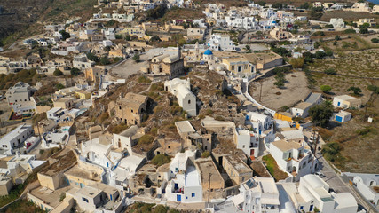 Fototapeta premium Aerial drone photo of iconic small traditional village of Akrotiri near famous archaeological site, Santorini island, Cyclades, Greece
