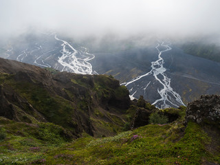 View from top of Valahnukur mountain on landscape of green valley of Thorsmork with sharp green...