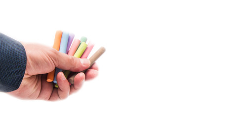Colored crayons in hand for creativity