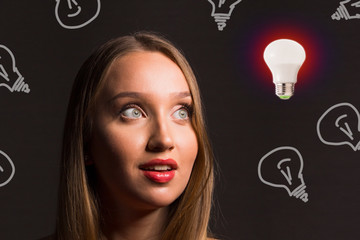 Blond businesswoman with light bulb looks like a creative idea or female startup.