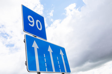Road sign Low speed limitation 90 km per hour with traffic direction sign