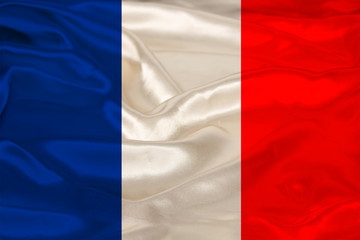 photo of the beautiful colored national flag of the modern state of France on textured fabric, concept of tourism, emigration, economics and politics, closeup