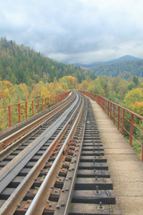 Fototapeta premium Railroad through the autumn mountains.