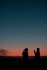 Fototapeta na wymiar Silhouette of tourists watching the sunset