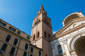 Fototapeta na wymiar Symmetrical view of a church tower between two ancient buildings